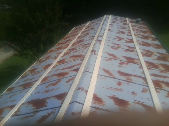 Rusted metal roof panels with new wood purlins before replacement — Storm Damage Roof Repair in Rocky Hill by Roofing Brothers