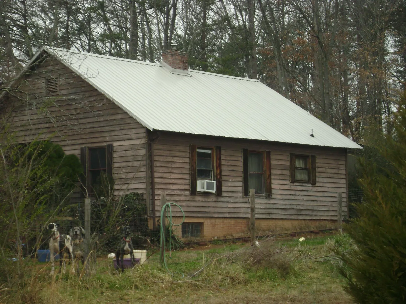 White metal roof on an old wood sided farmhouse, from a Metal Roof Installation job in Rocky Hill